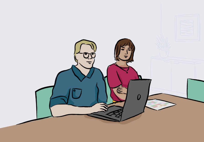 Två vuxna, en man och en kvinna sitter framför en laptop.